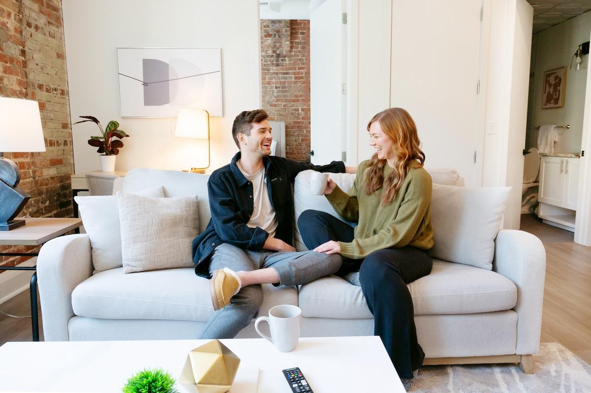 couple laughing together on couch